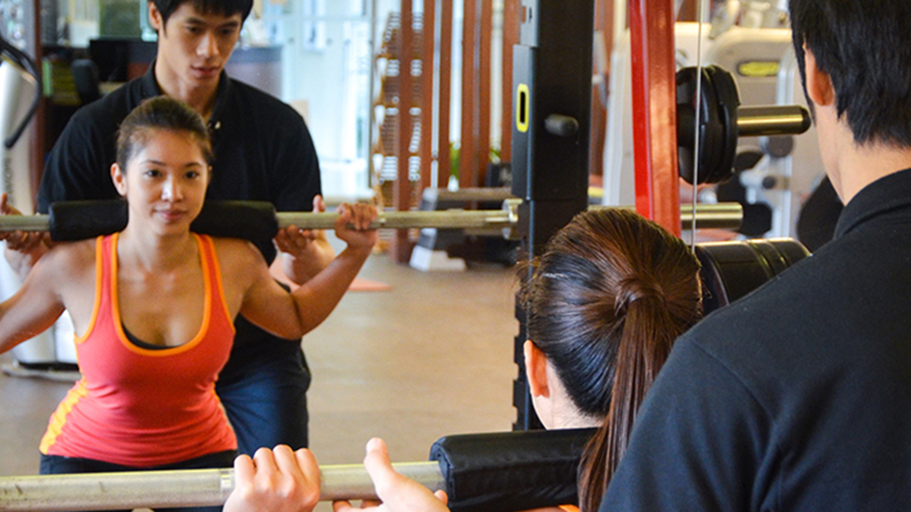 Trainer helping client Aileron Wellness
